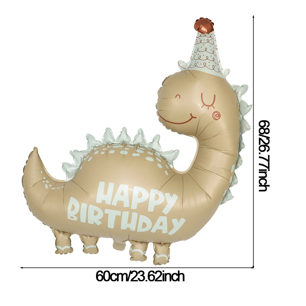 A beige foil balloon shaped like a cute, smiling dinosaur with a party hat and birthday message