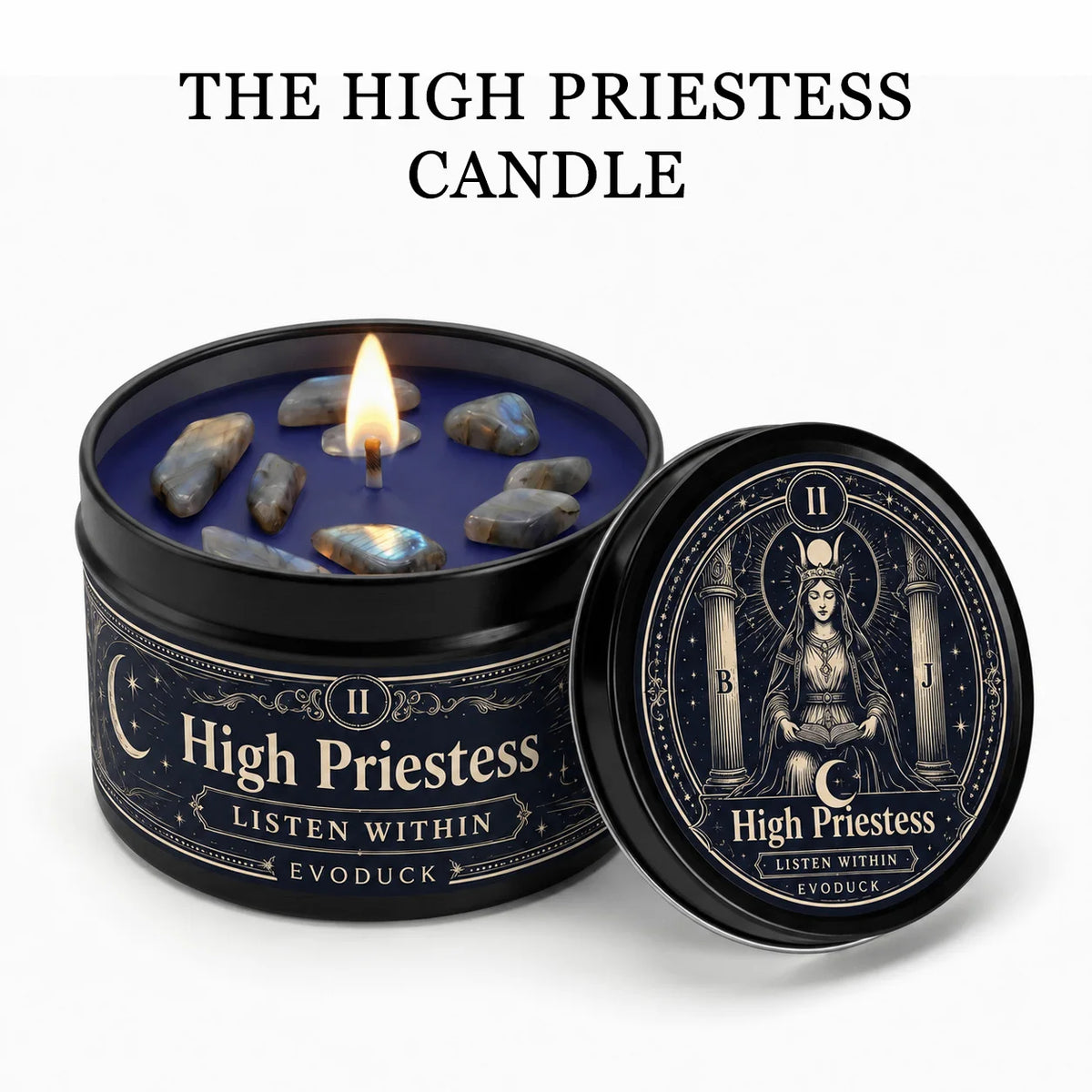 A dark candle jar labeled High Priestess with crystal stones and a lit wick, next to an open lid.