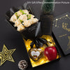 A gift presentation featuring a bouquet of handcrafted soap roses in a gold box with a red apple and pinecone.