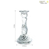 A tall, elegant clear glass pillar candle holder with a swirling design.