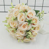 A bouquet of elegant white silk roses with light green filler flowers