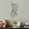 Minimalist abstract face metal wall art featuring a continuous line drawing of a profile