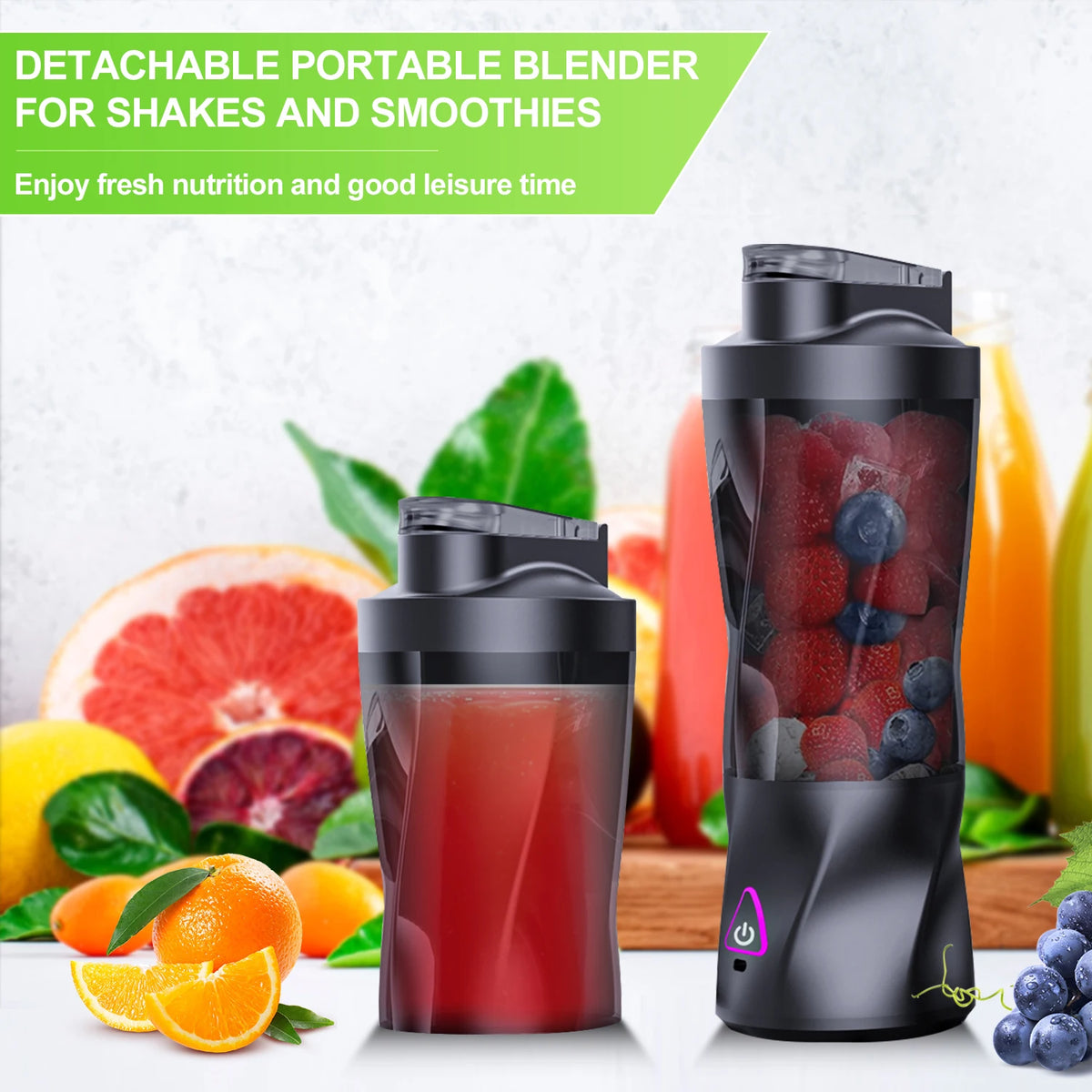A black portable blender jar filled with red juice sits next to fresh citrus fruits and blueberries.