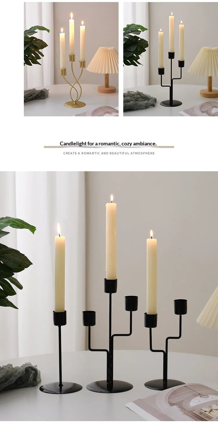 A black iron candle holder with a cream-colored candle on a white table, set in a bright room.