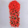 A dense hanging garland made of bright orange-red artificial flowers for wedding and home decor