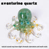 A translucent green aventurine quartz octopus statue with gold accents.