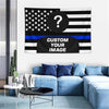 A black and white American flag tapestry featuring a question mark and blue stripes, displayed in a modern living room settin