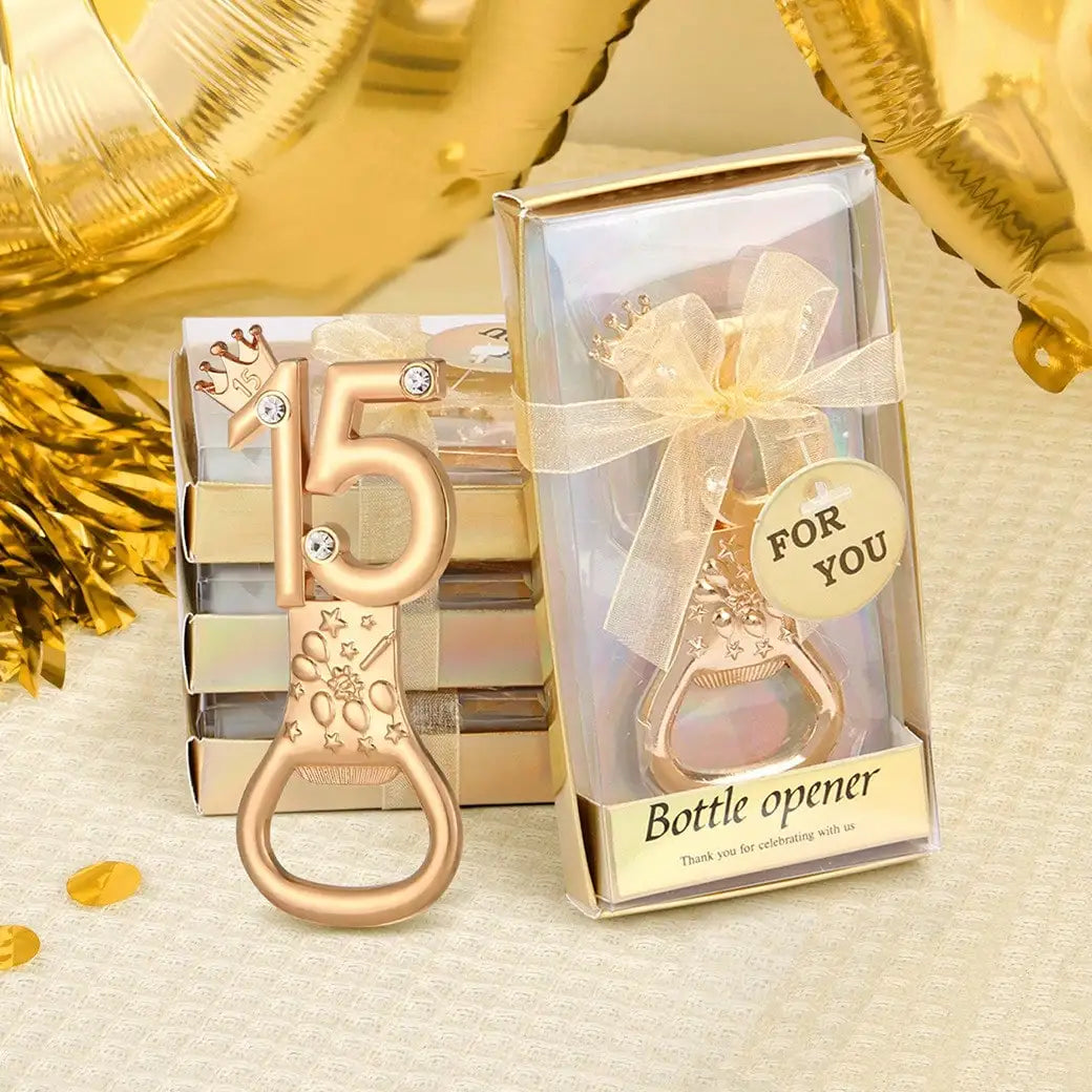 A gold crown number 15 bottle opener is displayed in a clear box with a gold ribbon, set against a light background.