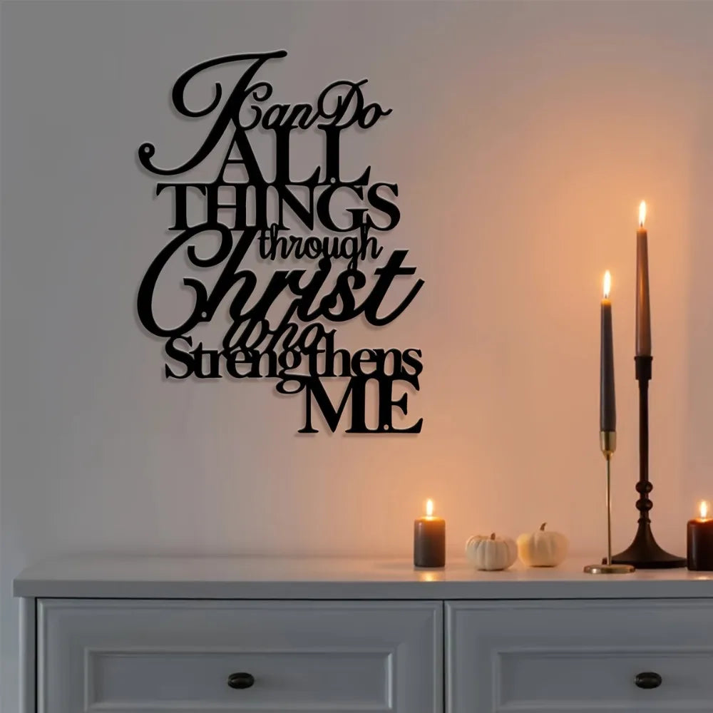 Black script wall art featuring the verse "Fan Do All Things Through Christ Who Strengthens Me" displayed on a white shelf.