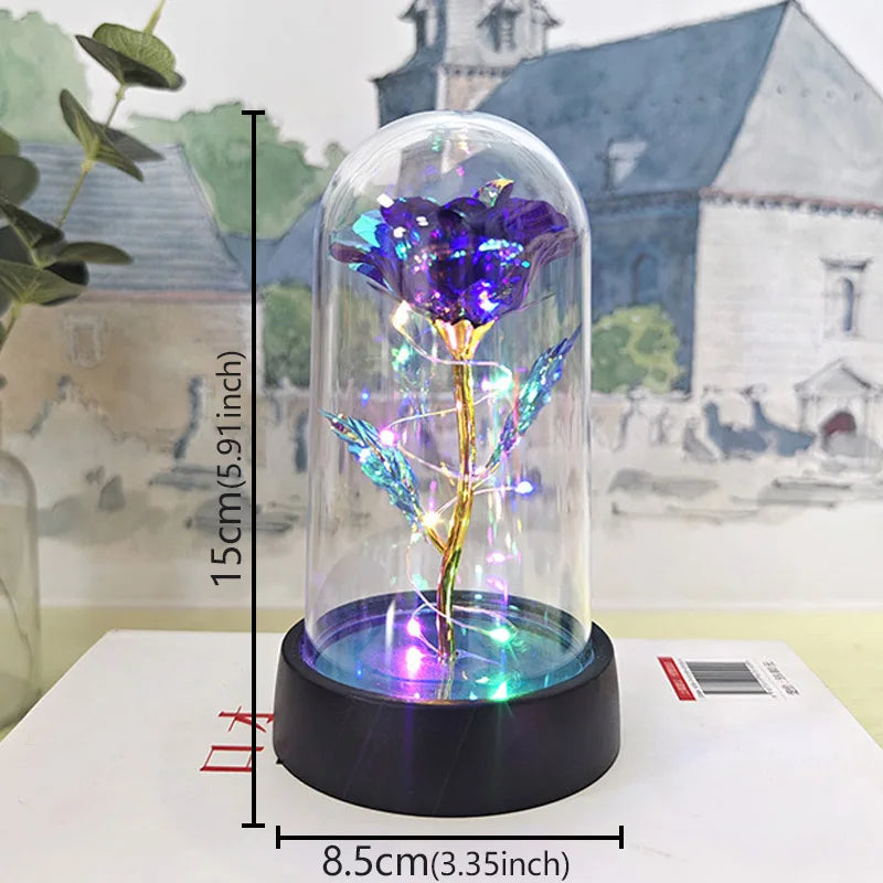 A glass dome featuring a purple rose with glowing LED light, displayed on a black base.
