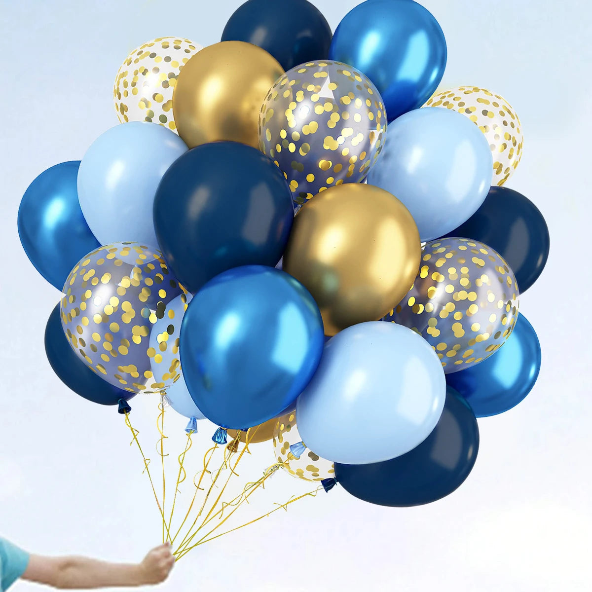 A cluster of metallic gold and blue pearl balloons with confetti accents floating against a light background.