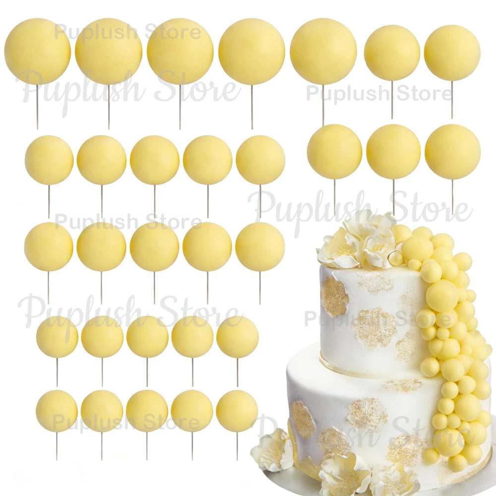 A set of yellow foam cake toppers displayed on white sticks and a white cake.