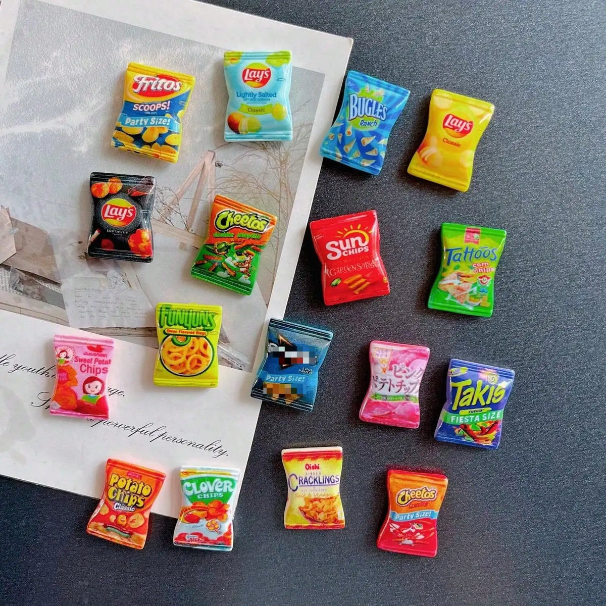 A collection of ten colorful candy-shaped refrigerator magnets including Lay's, Bugles, and Cheetos.