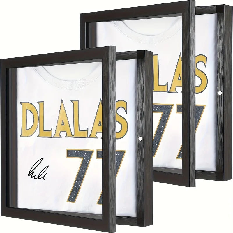 A set of three black wooden frames displaying a white jersey with gold lettering and a signature.