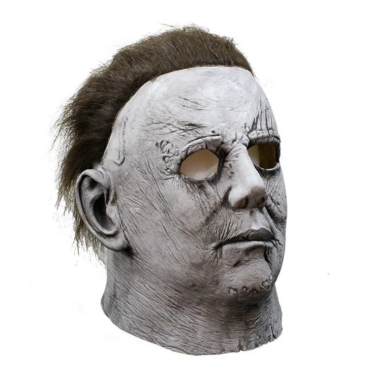 A gray latex horror mask resembling Michael Myers with a bald head and emotionless expression.