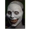 A white latex mask resembling a ghostly face with exaggerated features and a headscarf.