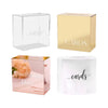 A set of four clear and gold acrylic gift boxes for cards, including a pink customized box and a white box.