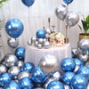 A collection of chrome metallic blue and silver balloons arranged on a table with floral decorations.
