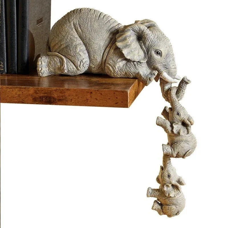 A resin figurine set of an elephant hugging a baby, resting on a wooden surface.