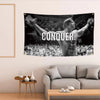 A black and white tapestry featuring Arnold Schwarzenegger in a muscular pose with the word CONQUER visible.