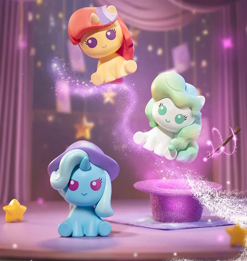 Three My Little Pony Magic Bottle collectible figurines in pink, green, and blue are suspended against a purple background.