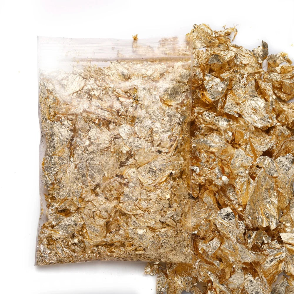 A pile of shiny gold foil flakes used for resin art and jewelry making.
