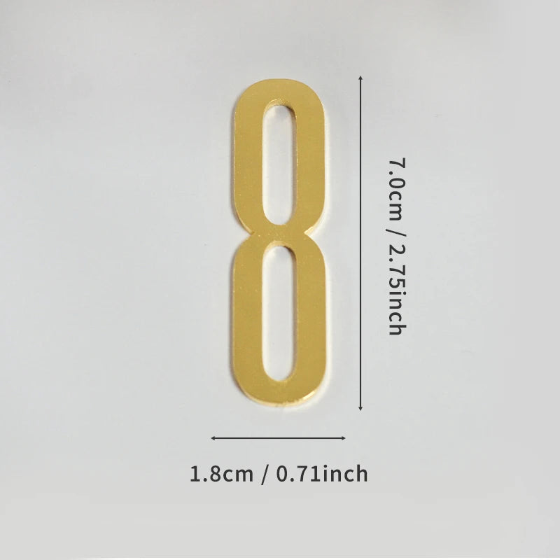 A polished gold house number shaped like the numeral 8 with a self-adhesive backing.