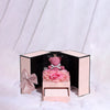 A pink gift box containing a cute bear rose pendant necklace.