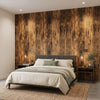 A bedroom featuring a bed with light green bedding against a dark wood grain accent wall.