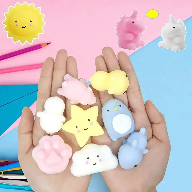 A hand holds various small, squishy cartoon animal stress relief toys in pink, yellow, and white colors.