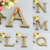 A set of 3D golden letter mirror wall decals spelling out the letters A, N, M, L, I, and Q.