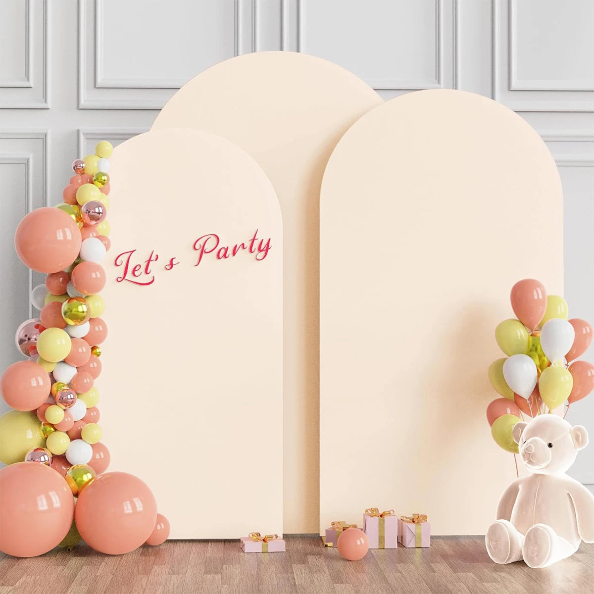 A light pink arch stand backdrop decorated with balloons and a 'Let's Party' sign for an event.