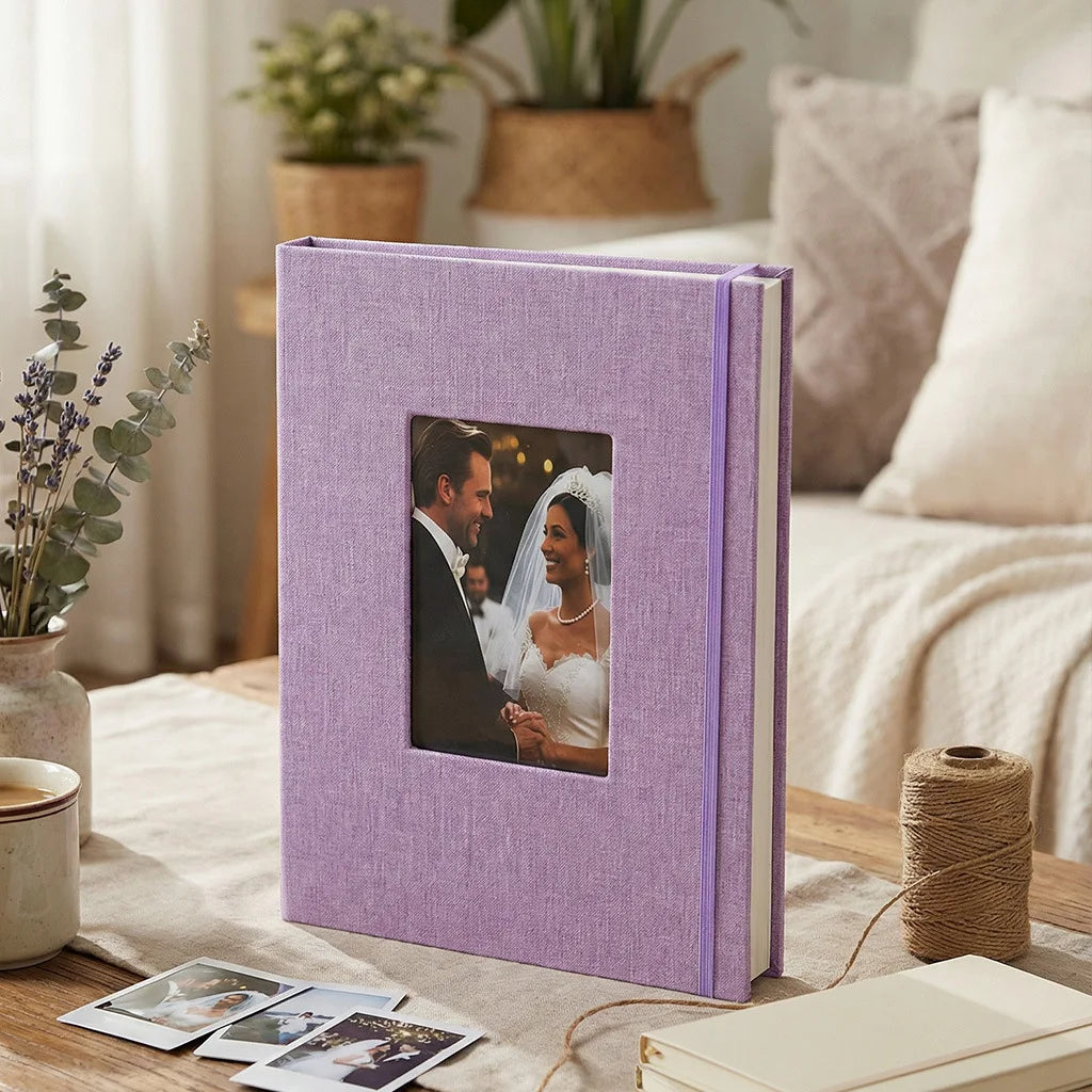 A purple linen photo album with a square photo insert resting on a wooden surface.