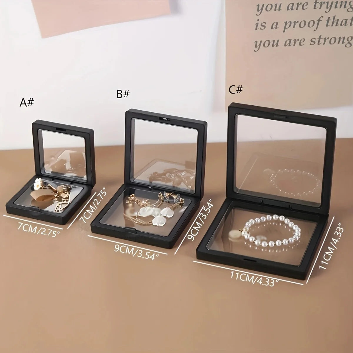 Three transparent floating display boxes for jewelry and collectibles shown in different sizes labeled A, B, and C