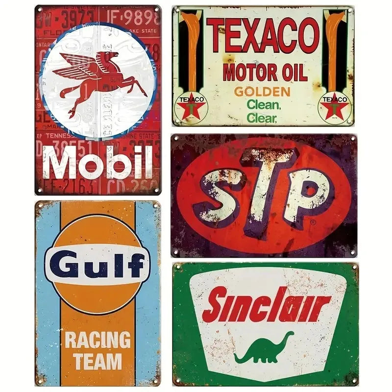 A collection of vintage metal tin signs featuring brands like Texaco, Mobil, Gulf, and Sinclair Racing Team.