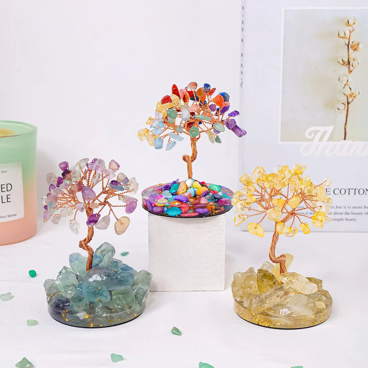 A display of natural chakra healing crystal trees featuring colorful stones and branches for home decor.