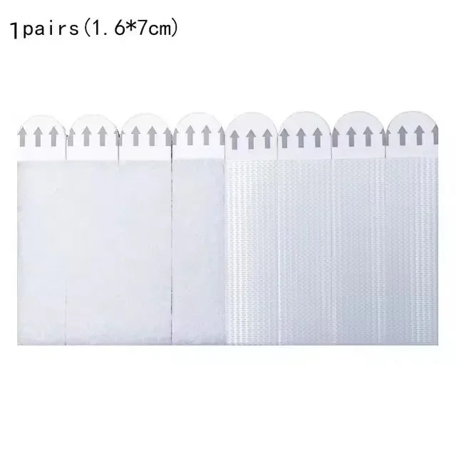 One pair of reusable double-sided adhesive picture hanging strips with small white arrows on the top.