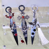 Three decorative gothic kunai utility knives with silver and black accents displayed in a clear case.