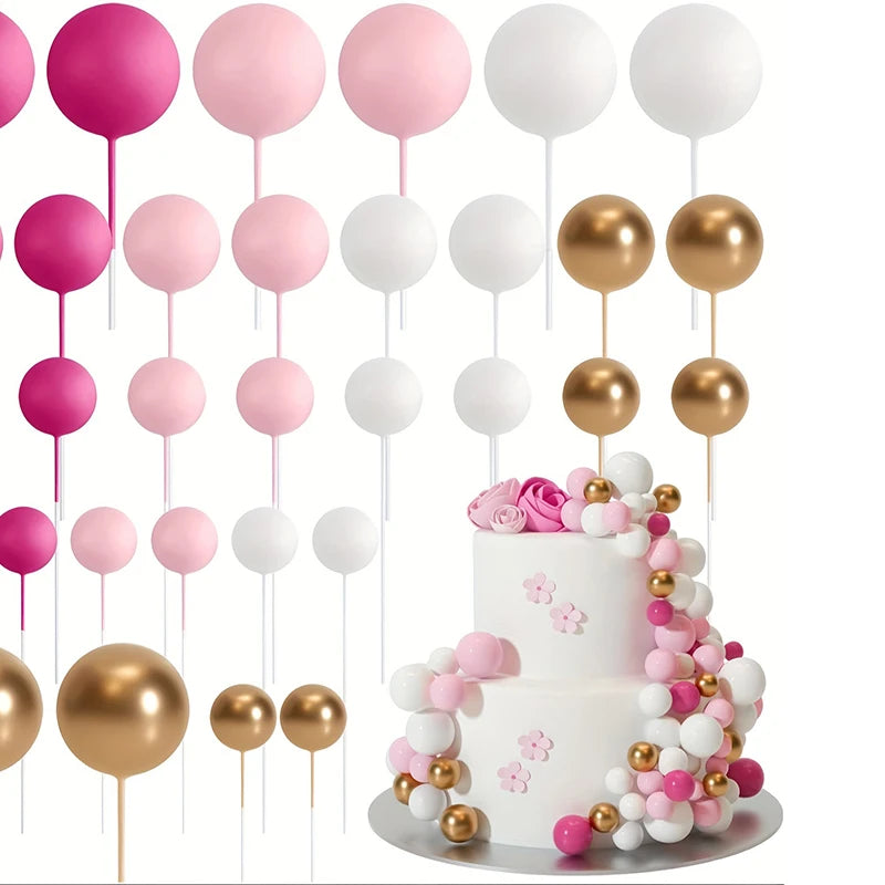 A set of twenty pink and white ball cake toppers on sticks arranged around a white tiered cake.
