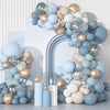 A balloon arch kit featuring dusty blue and sand white balloons with gold confetti accents.