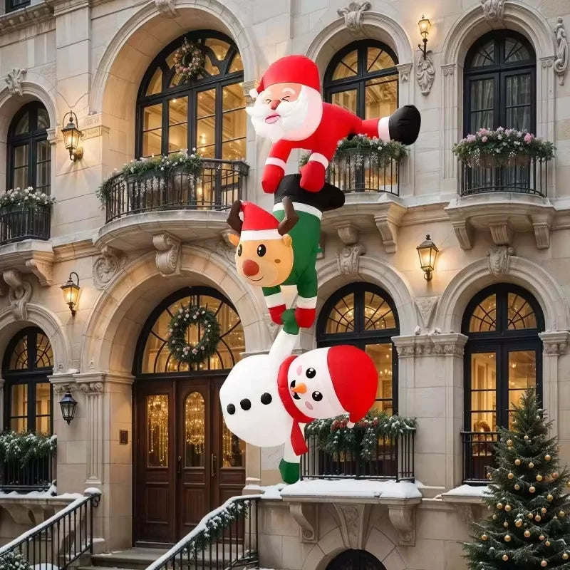 An inflatable decoration featuring Santa, a reindeer, and a snowman stacked on a building facade.
