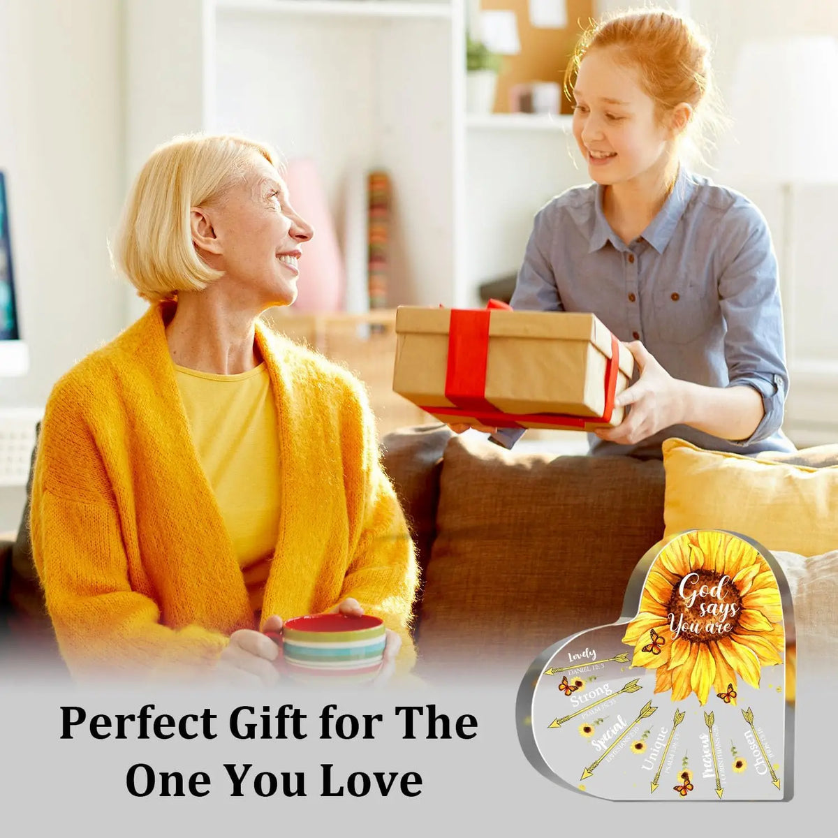 A young girl smiles while holding a gift box, with an older woman looking at the gift. The plaque is shown in the corner.