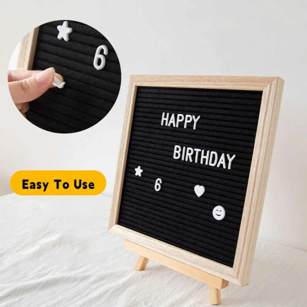A wooden message board with the number 6 and birthday message written in white stars and hearts
