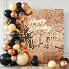 A square wall backdrop covered in gold and bronze sequins with the text Happy Birthday in sparkling gold script.