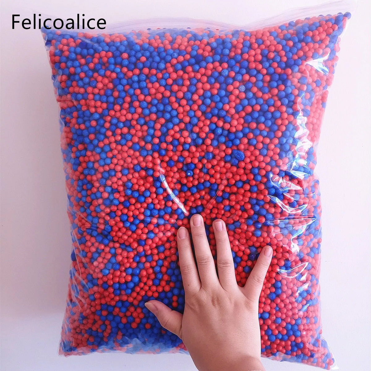 A bag filled with red and blue foam beads for crafting and decoration