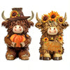 A set of two rustic wooden Highland cow figurines decorated with autumn leaves and pumpkins.