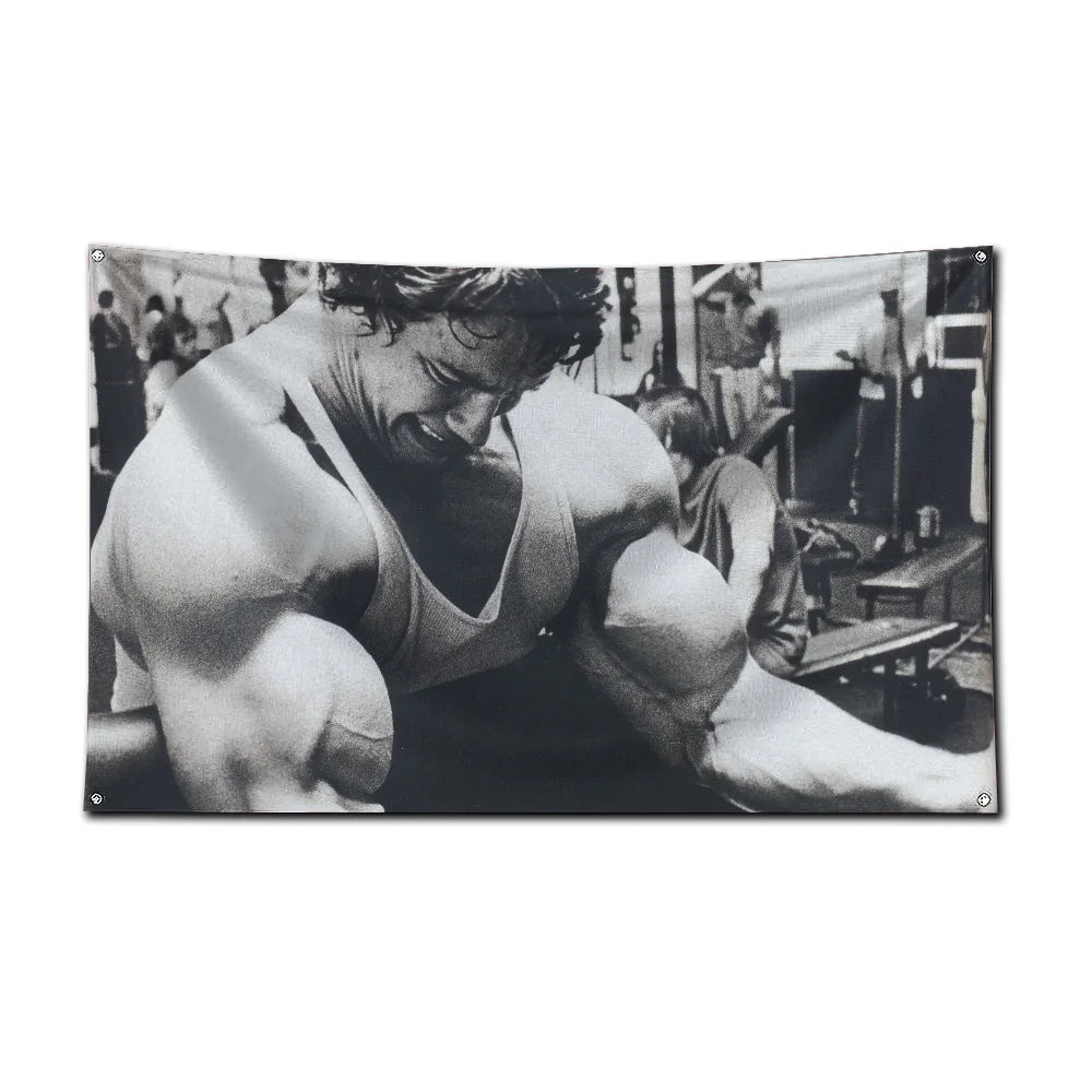 A black and white photograph of a muscular man exercising in a gym setting.