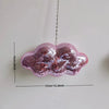 Pink glittery cloud shaped ornament hanging by a chain