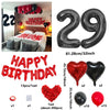 A set of red and black birthday balloons including a 29-inch foil balloon, heart-shaped balloons, and a cluster of red balloo