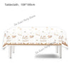 A white tablecloth decorated with gold floral patterns and 'hello baby' text for a gender reveal or baby shower.